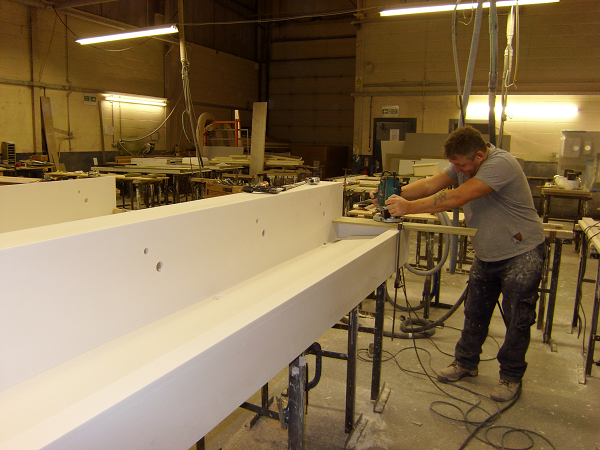 Man working on solid stone sink trough